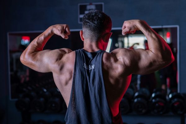 A man flexing his muscles in a gym